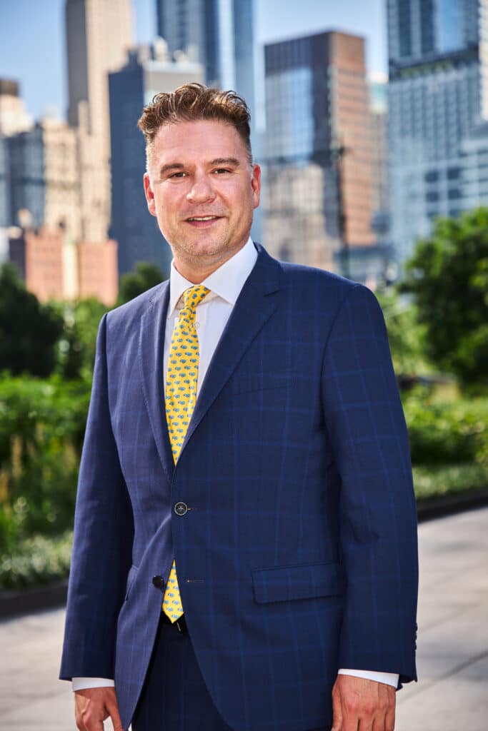 Michael Kusz headshot outside of Shulman & Hill's Manhattan Office