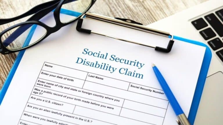 a social security claim form with a pen and glasses