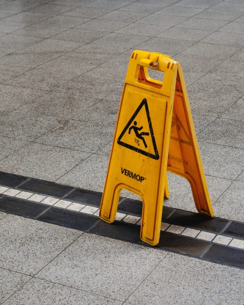 a yellow sign on the ground