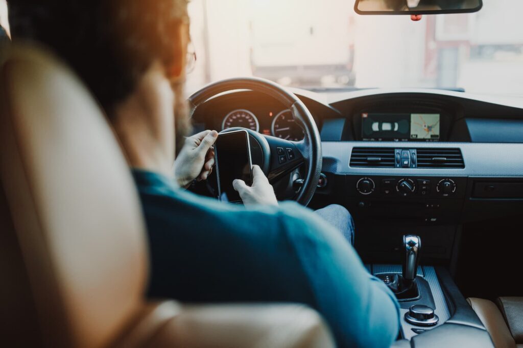 a person holding a phone in a car