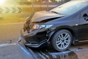 a black car with a damaged front end