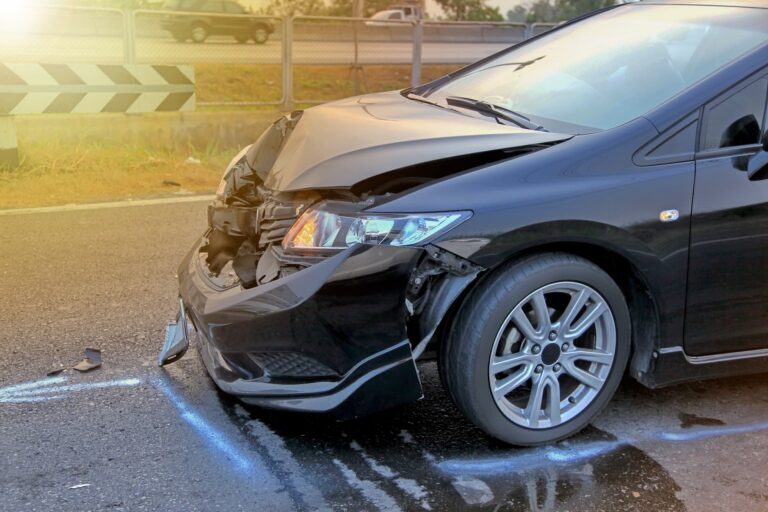 a black car with a damaged front end