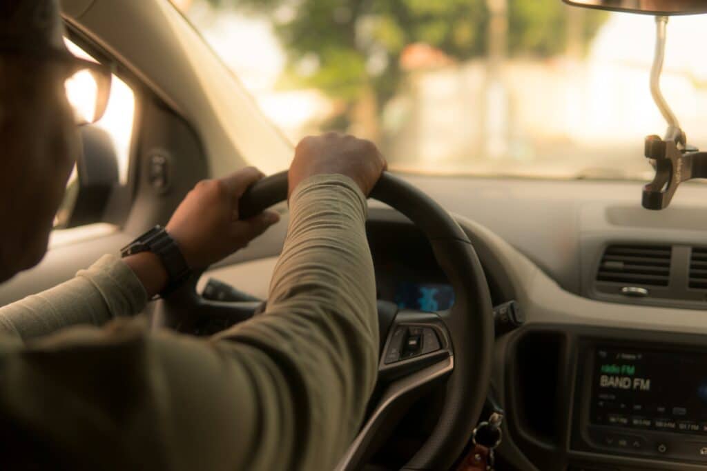 a person holding a steering wheel