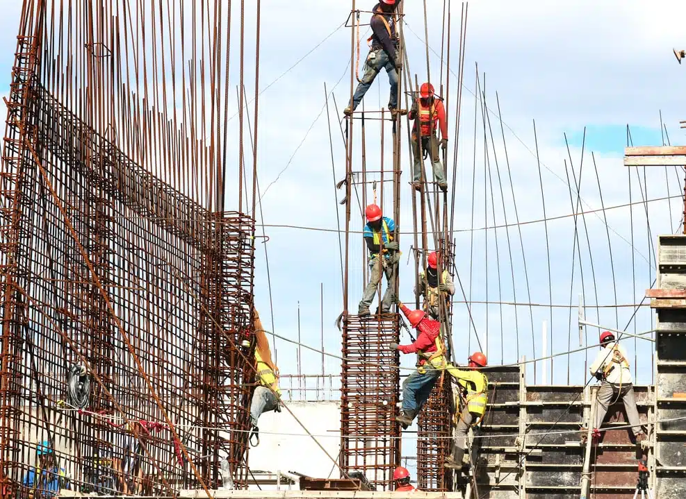 Construction workers reinforcing steel bars at a building site