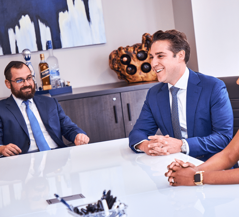 Attorneys in a conference room discussing a case while seated at a table